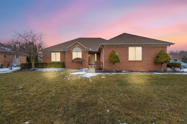 ranch-style house featuring a lawn