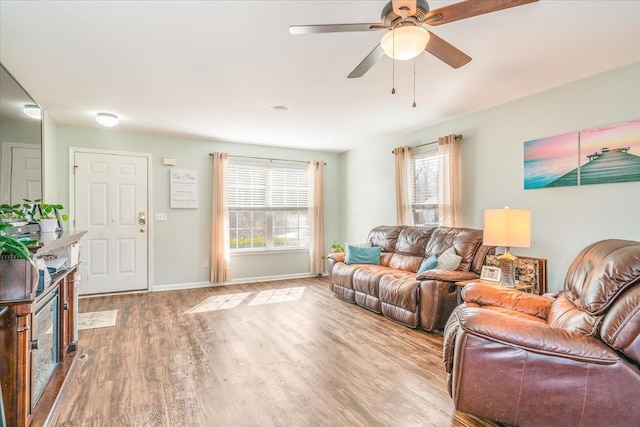 living room with hardwood / wood-style floors and ceiling fan