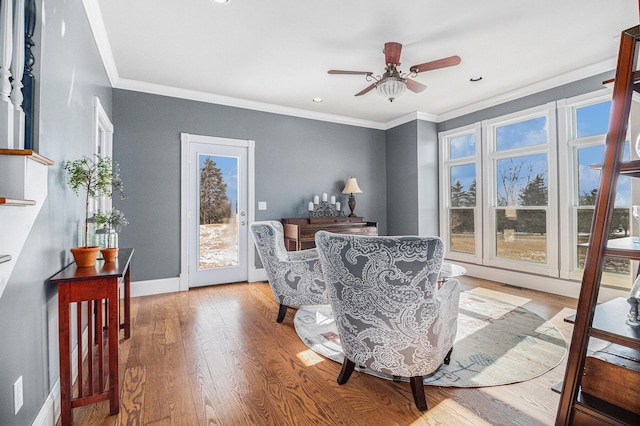 interior space with crown molding, ceiling fan, and light wood-type flooring