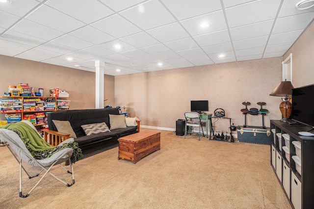 living room featuring a paneled ceiling and carpet