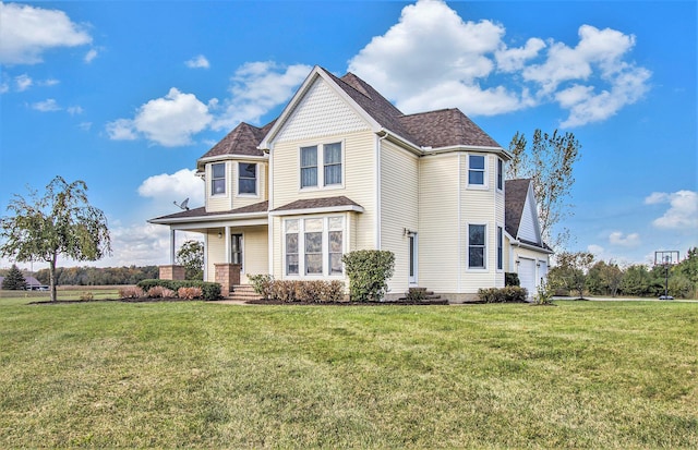 view of front of house featuring a garage, a front yard, and covered porch