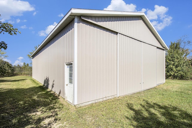 view of side of property featuring an outbuilding and a yard