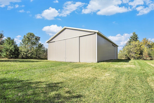 view of outbuilding featuring a yard