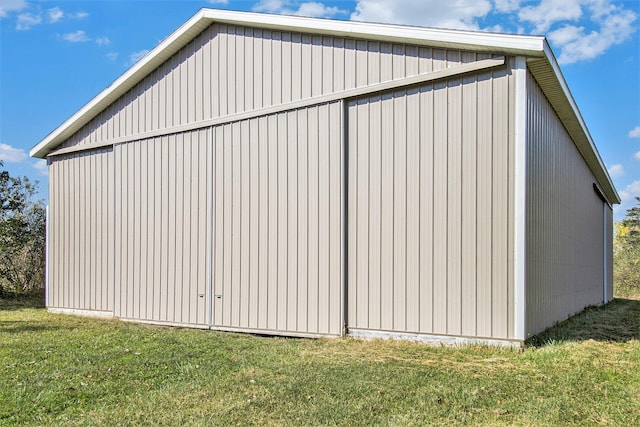 view of side of property with a yard and an outdoor structure