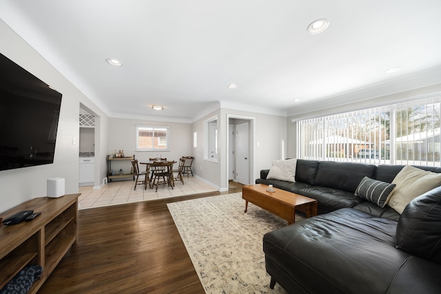 living room with hardwood / wood-style flooring and crown molding