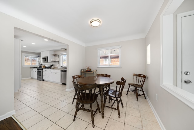 tiled dining area featuring sink