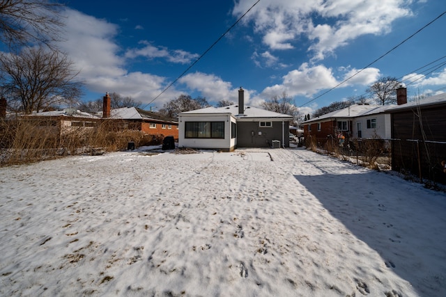 view of snow covered rear of property