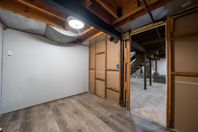 basement with hardwood / wood-style floors