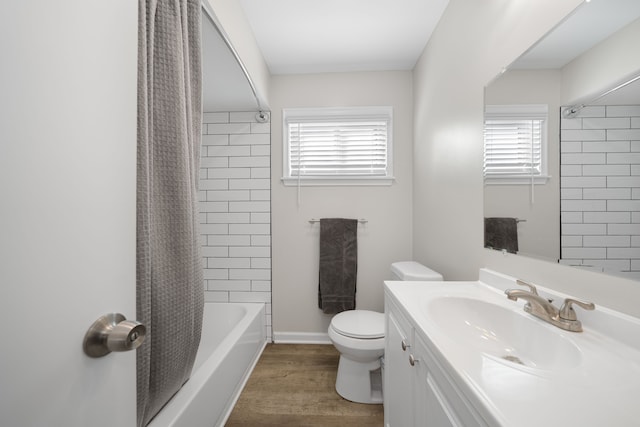 full bathroom with vanity, hardwood / wood-style floors, shower / bathtub combination with curtain, and toilet