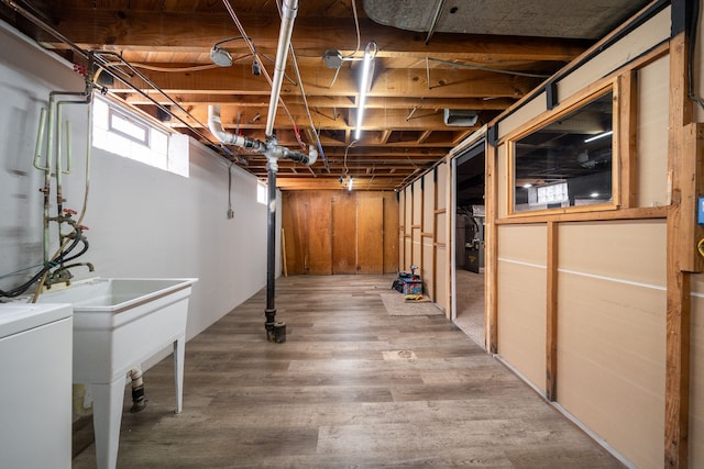 basement featuring hardwood / wood-style flooring and washer / clothes dryer