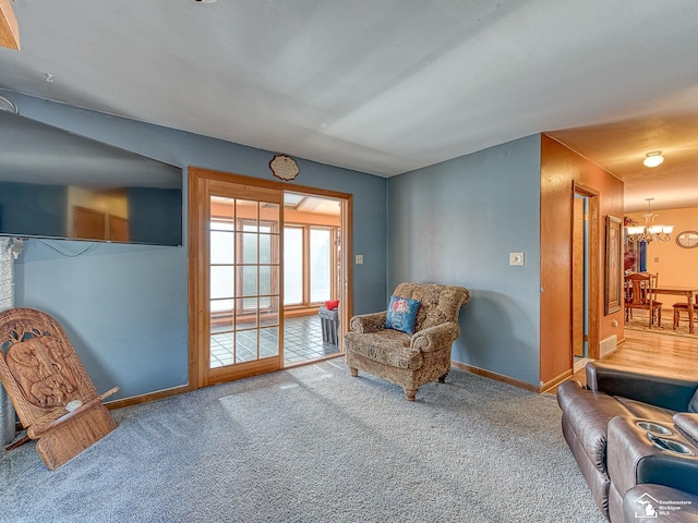 living area with carpet floors and a notable chandelier