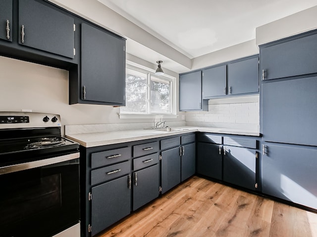 kitchen featuring range with electric cooktop, sink, decorative backsplash, paneled built in refrigerator, and light hardwood / wood-style flooring