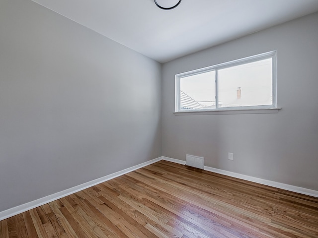 empty room with light hardwood / wood-style floors