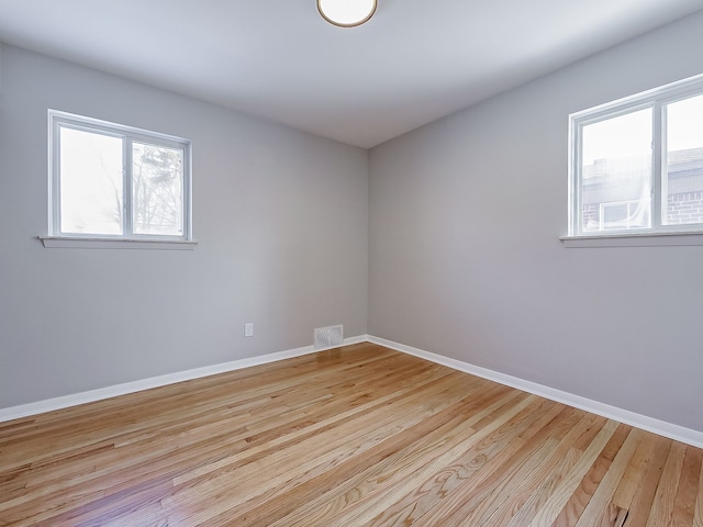 empty room with plenty of natural light and light wood-type flooring