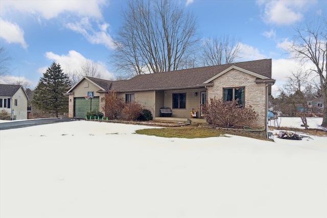 ranch-style house featuring brick siding, driveway, and an attached garage