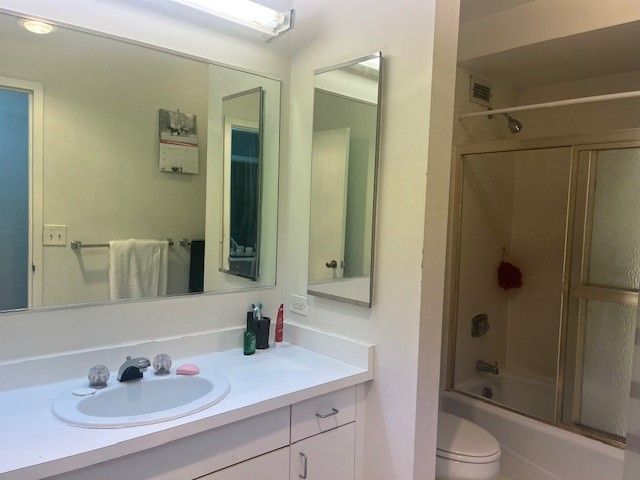 bathroom with visible vents, vanity, toilet, and washtub / shower combination