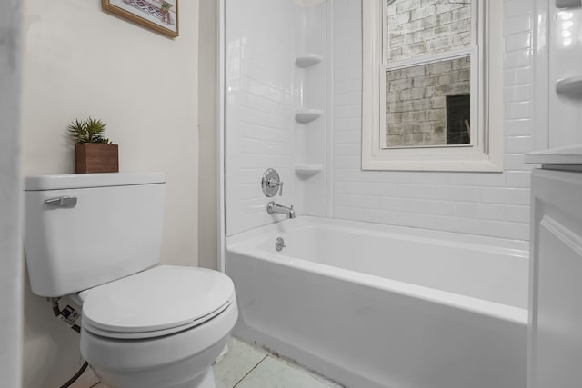 bathroom with tiled shower / bath, toilet, and tile patterned flooring