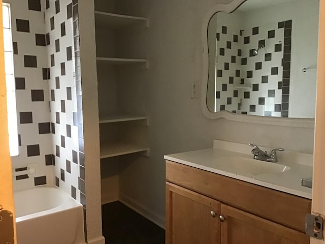 bathroom with vanity and tiled shower / bath combo