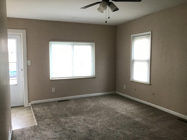 empty room with ceiling fan and carpet