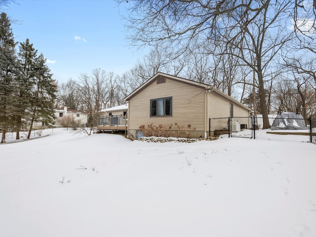 view of snow covered exterior with a wooden deck