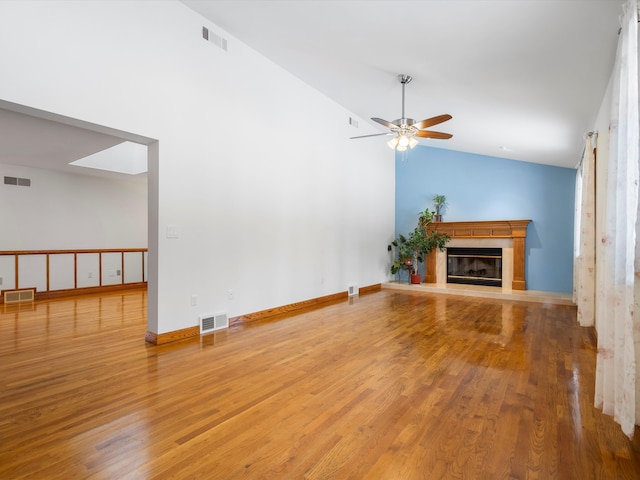 unfurnished living room with vaulted ceiling, ceiling fan, and hardwood / wood-style flooring