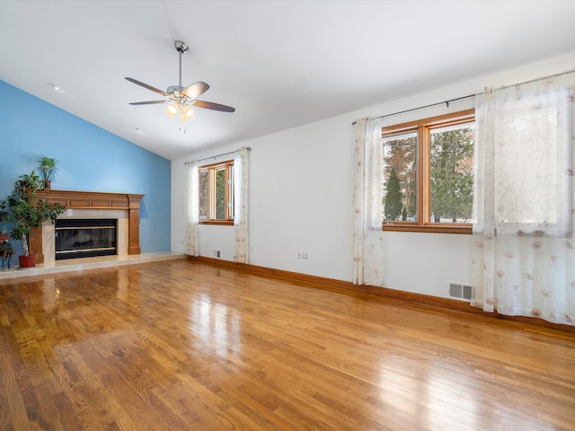 unfurnished living room featuring hardwood / wood-style flooring, vaulted ceiling, and ceiling fan