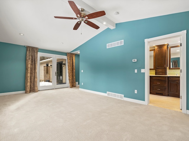 spare room with light carpet, ceiling fan, and lofted ceiling with beams