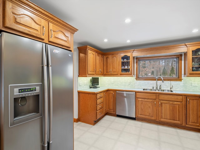 kitchen featuring stainless steel appliances, backsplash, and sink