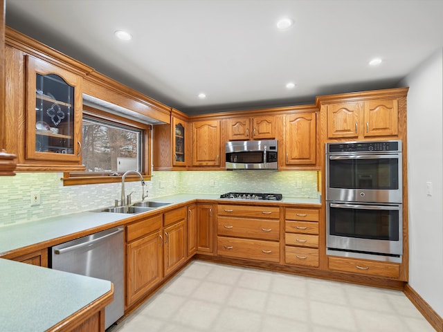 kitchen featuring sink, tasteful backsplash, and stainless steel appliances