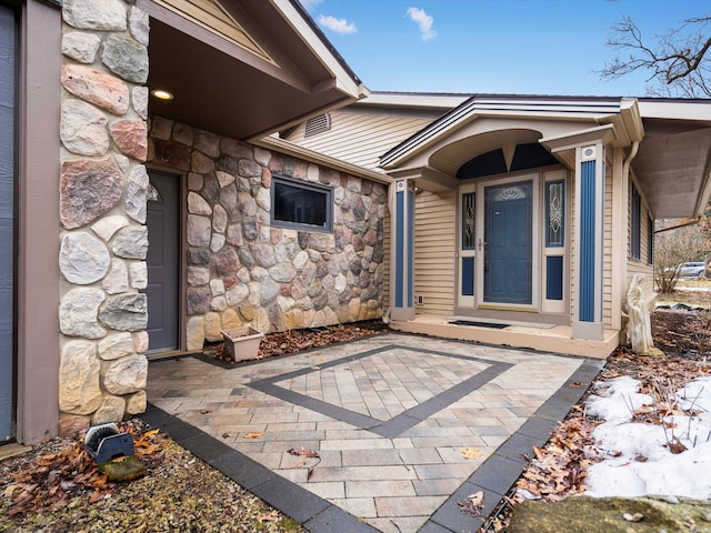 entrance to property featuring stone siding