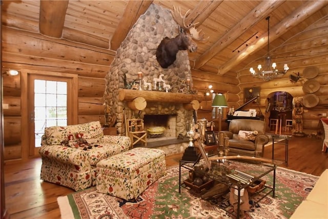 living room featuring vaulted ceiling with beams, hardwood / wood-style flooring, and a fireplace