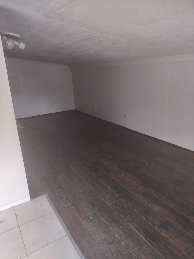 unfurnished room featuring hardwood / wood-style flooring and a textured ceiling