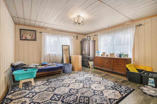 sitting room featuring hardwood / wood-style floors, a wealth of natural light, and wood walls