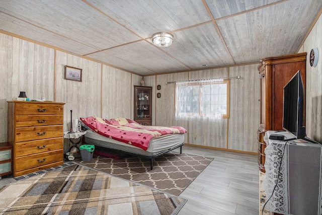 bedroom featuring hardwood / wood-style flooring, wooden ceiling, and wood walls