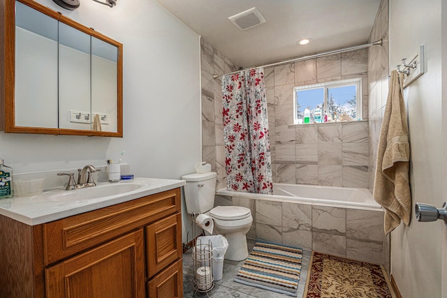 full bathroom featuring shower / tub combo, vanity, and toilet