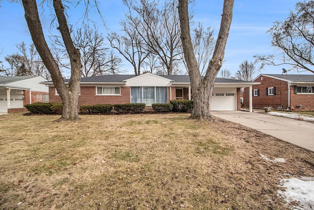 ranch-style home featuring driveway, brick siding, a front lawn, and an attached garage