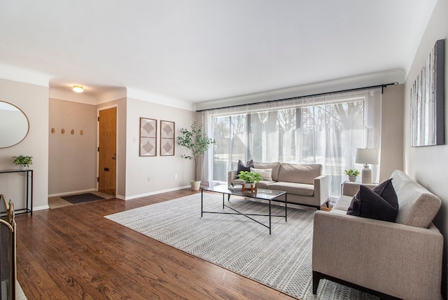 living area featuring baseboards and wood finished floors