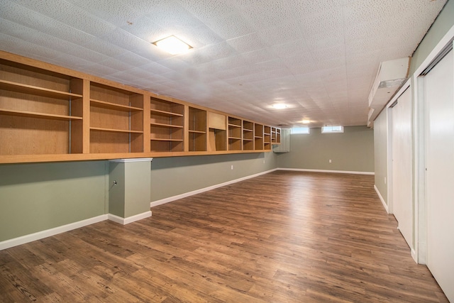 basement with dark wood finished floors and baseboards