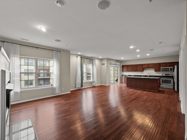 unfurnished living room featuring dark hardwood / wood-style flooring and sink