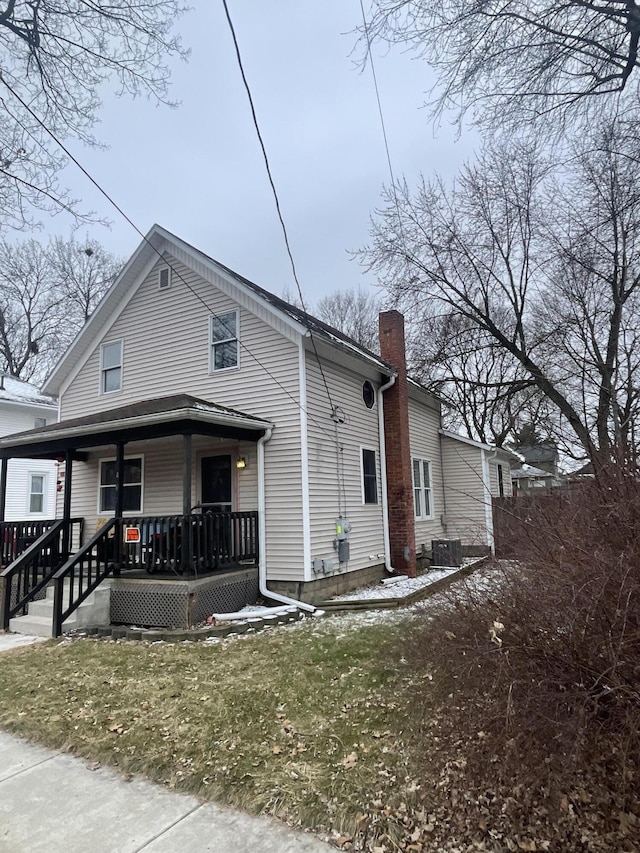 view of front facade with a porch and cooling unit