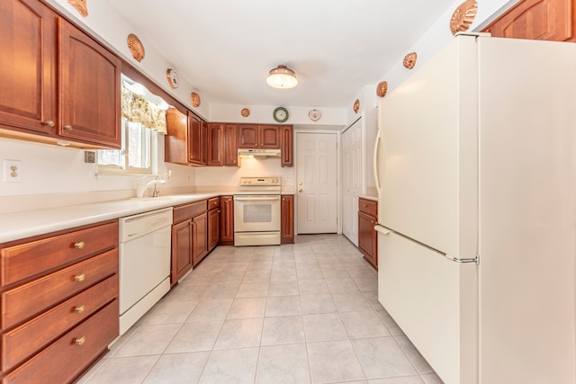 kitchen with sink, white appliances, and light tile patterned floors