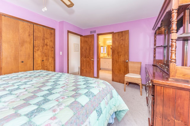 bedroom with ceiling fan, light carpet, and a closet