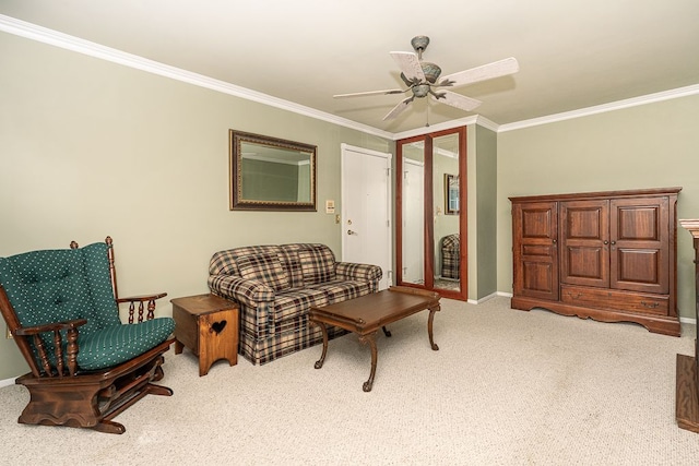 sitting room with carpet floors, ornamental molding, and ceiling fan