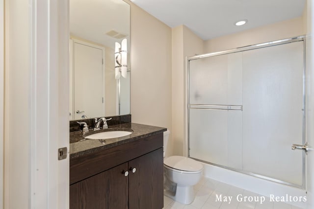 bathroom featuring vanity, toilet, an enclosed shower, and tile patterned flooring