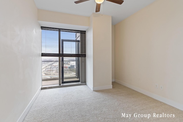 spare room with light carpet and ceiling fan