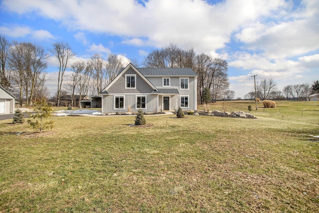 rear view of house with a porch and a lawn