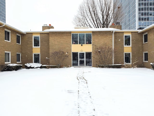 view of snow covered rear of property