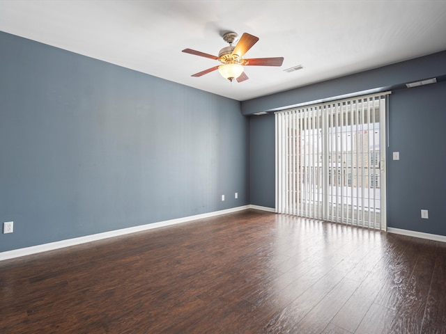 spare room featuring dark hardwood / wood-style flooring and ceiling fan