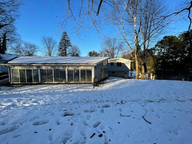 view of snow covered back of property