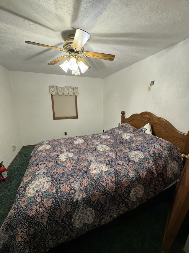 carpeted bedroom featuring ceiling fan and a textured ceiling